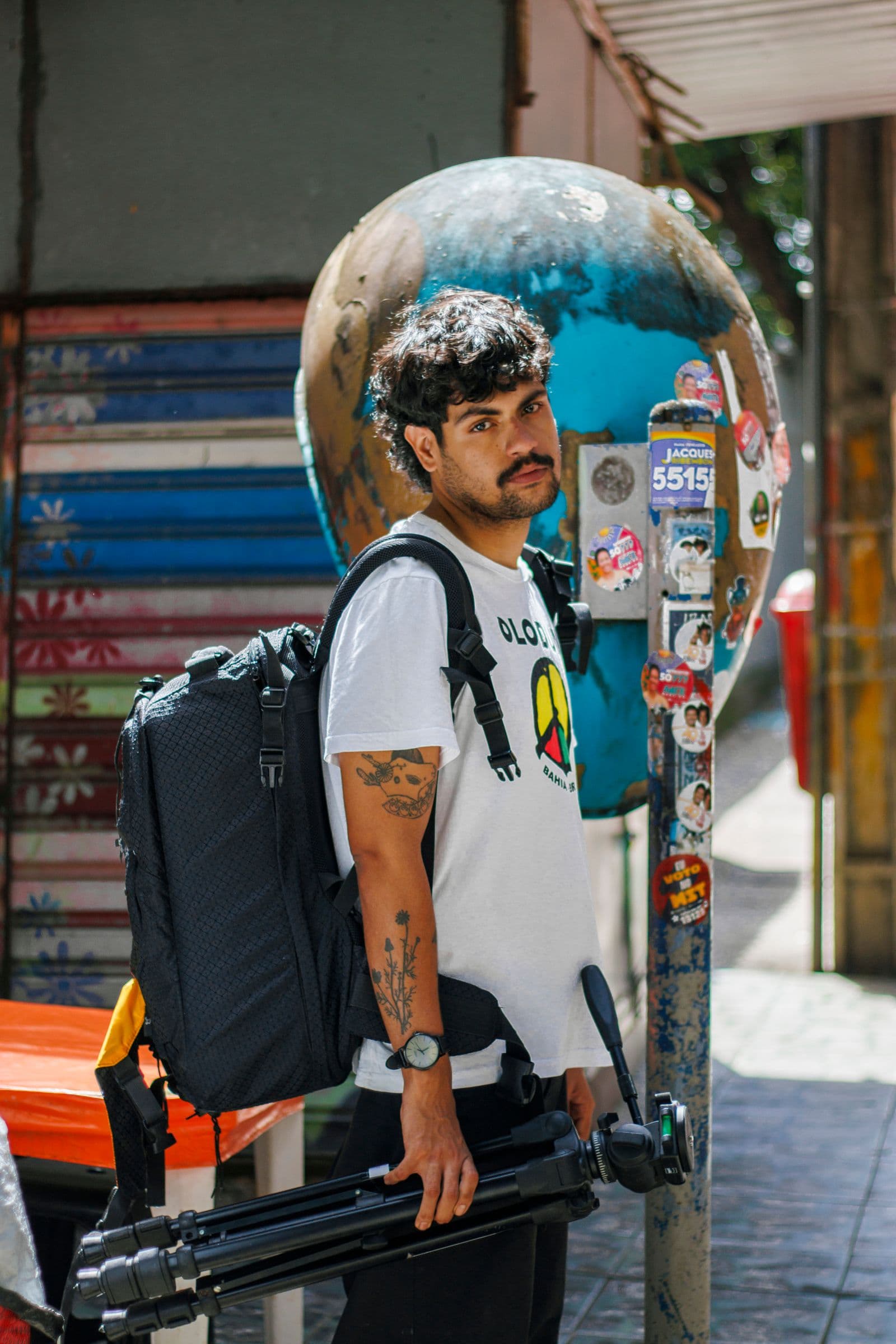 A street photographer carrying camera equipment in Sao Paulo